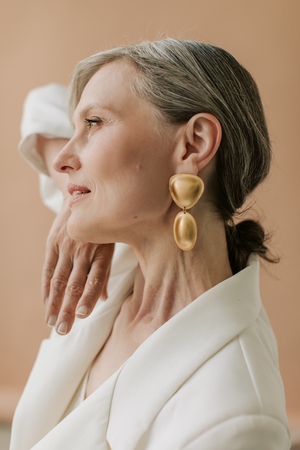 Elegant Senior Woman in Gold Earrings